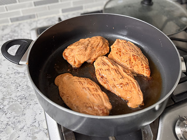 Fried chicken breasts brushed with dipping sauce.